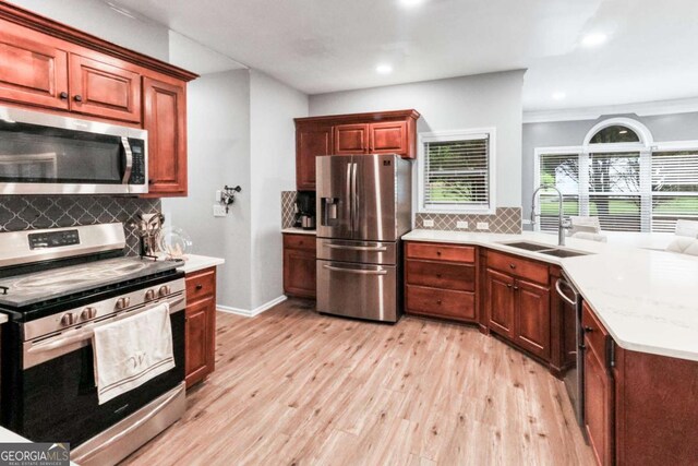 3898 Heritage Oaks Dr, Powder Springs, GA 30127 - kitchen featuring appliances with stainless steel finishes, a sink, light wood-style floors, tasteful backsplash, and recessed lighting