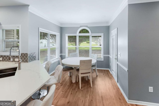 3898 Heritage Oaks Dr, Powder Springs, GA 30127 - dining area featuring light wood-style flooring, baseboards, and ornamental molding