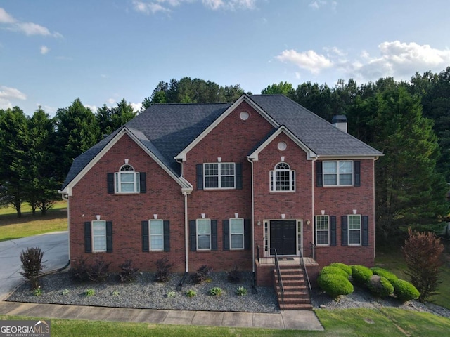 3898 Heritage Oaks Dr, Powder Springs, GA 30127 - colonial inspired home featuring a chimney and brick siding