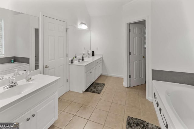 3898 Heritage Oaks Dr, Powder Springs, GA 30127 - bathroom featuring two vanities, a garden tub, and tile patterned floors