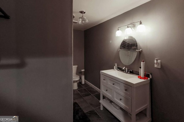 3898 Heritage Oaks Dr, Powder Springs, GA 30127 - bathroom with vanity, toilet, tile patterned floors, and baseboards