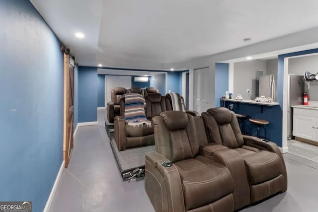 3898 Heritage Oaks Dr, Powder Springs, GA 30127 - cinema with a barn door, baseboards, concrete flooring, and recessed lighting