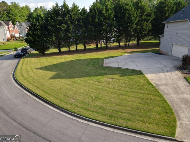 3898 Heritage Oaks Dr, Powder Springs, GA 30127 - view of green lawn with an attached garage, driveway, and a residential view