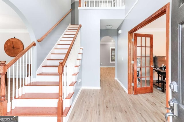 3898 Heritage Oaks Dr, Powder Springs, GA 30127 - foyer with arched walkways, wood finished floors, ornamental molding, baseboards, and stairs