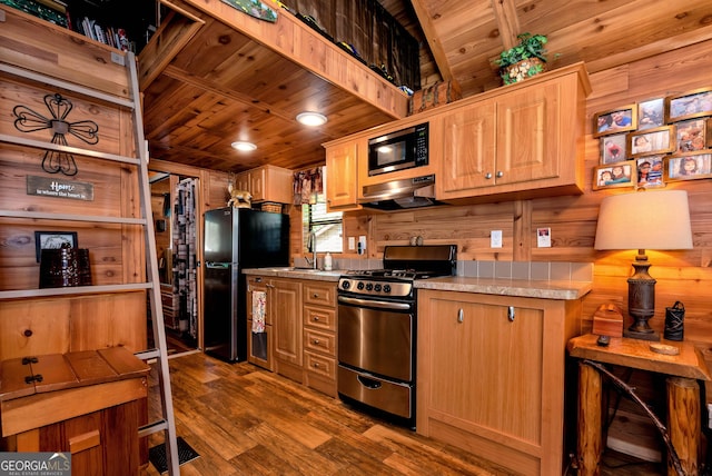76 Hidden Valley Rd, Cleveland, GA 30528 - kitchen with gas stove, freestanding refrigerator, under cabinet range hood, light countertops, and dark wood finished floors