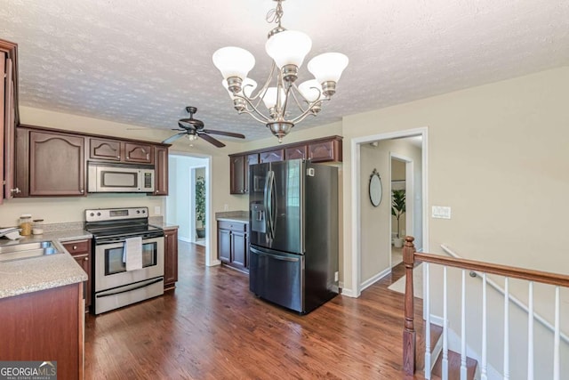3947 Veracruz Ct, Decatur, GA 30034 - kitchen with appliances with stainless steel finishes, a chandelier, light countertops, dark wood-style floors, and a textured ceiling