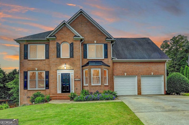 3760 Ansley Park Dr, Suwanee, GA 30024 - view of front of house featuring concrete driveway, brick siding, a lawn, and an attached garage