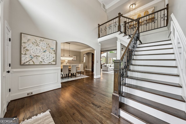 115 Hopewell Grove Dr, Milton, GA 30004 - foyer featuring arched walkways, ornamental molding, a towering ceiling, dark wood finished floors, and stairway
