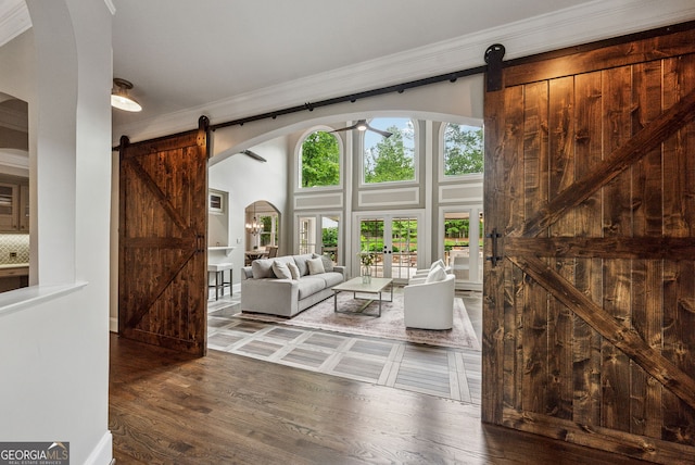 115 Hopewell Grove Dr, Milton, GA 30004 - living area featuring a barn door, arched walkways, ornamental molding, wood finished floors, and ceiling fan