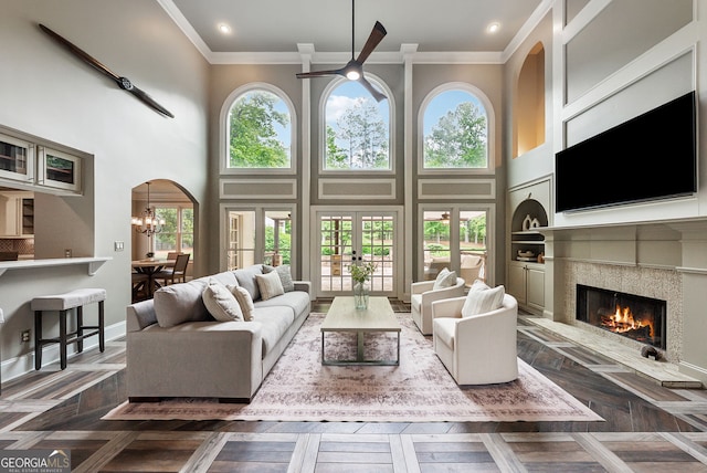 115 Hopewell Grove Dr, Milton, GA 30004 - living area featuring a tile fireplace, crown molding, plenty of natural light, a towering ceiling, and a ceiling fan