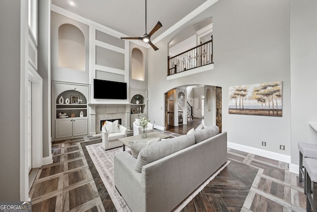 115 Hopewell Grove Dr, Milton, GA 30004 - living room with arched walkways, baseboards, built in shelves, ceiling fan, and ornamental molding