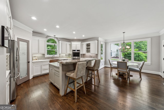 115 Hopewell Grove Dr, Milton, GA 30004 - kitchen featuring ornamental molding, stone countertops, tasteful backsplash, a sink, and white cabinetry