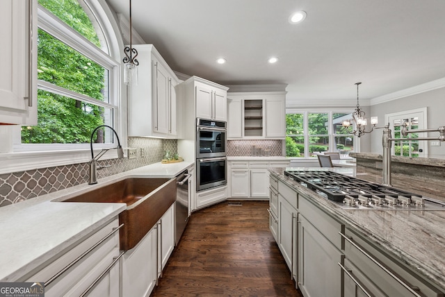 115 Hopewell Grove Dr, Milton, GA 30004 - kitchen featuring stainless steel appliances, white cabinets, backsplash, crown molding, and pendant lighting