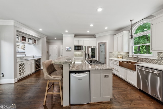 115 Hopewell Grove Dr, Milton, GA 30004 - kitchen featuring stainless steel appliances, a sink, beverage cooler, ornamental molding, and white cabinets
