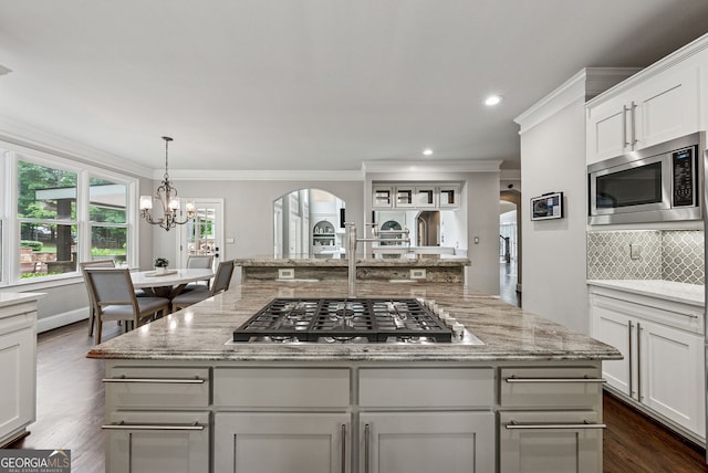 115 Hopewell Grove Dr, Milton, GA 30004 - kitchen with appliances with stainless steel finishes, arched walkways, tasteful backsplash, ornamental molding, and light stone countertops