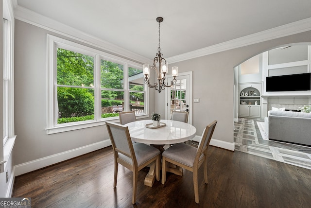 115 Hopewell Grove Dr, Milton, GA 30004 - dining space with crown molding, baseboards, a chandelier, dark wood-style flooring, and arched walkways