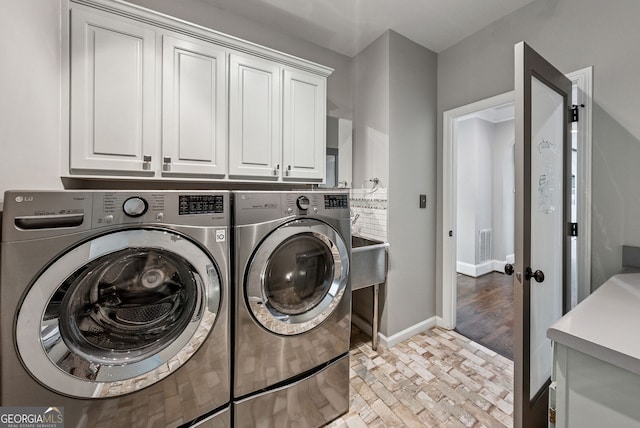 115 Hopewell Grove Dr, Milton, GA 30004 - laundry room featuring washer and clothes dryer, cabinet space, baseboards, and brick patterned flooring