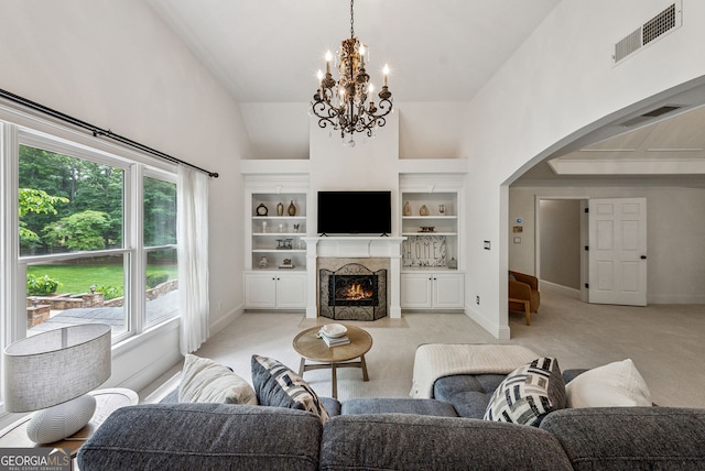 115 Hopewell Grove Dr, Milton, GA 30004 - living area with light colored carpet, arched walkways, a chandelier, a towering ceiling, and healthy amount of natural light
