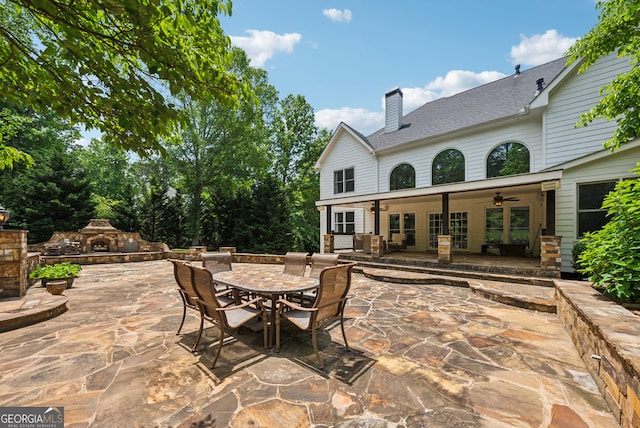 115 Hopewell Grove Dr, Milton, GA 30004 - view of patio / terrace with an outdoor stone fireplace, a ceiling fan, and outdoor dining space