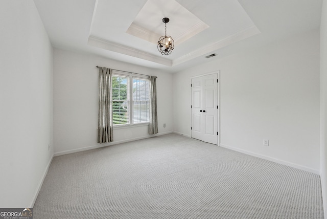 115 Hopewell Grove Dr, Milton, GA 30004 - spare room featuring a chandelier, light colored carpet, a raised ceiling, crown molding, and baseboards