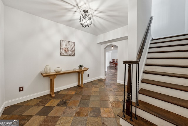 115 Hopewell Grove Dr, Milton, GA 30004 - foyer featuring stone tile flooring, arched walkways, baseboards, and stairs