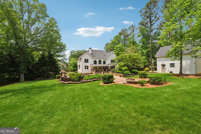 115 Hopewell Grove Dr, Milton, GA 30004 - back of house featuring a yard and a chimney