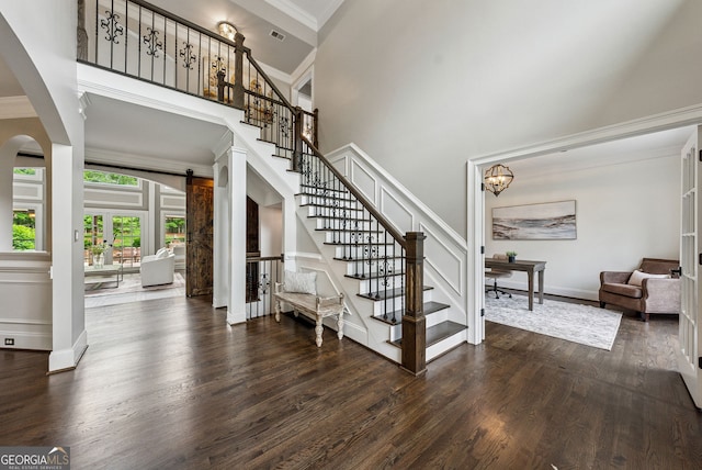 115 Hopewell Grove Dr, Milton, GA 30004 - stairs featuring wood finished floors, crown molding, a high ceiling, arched walkways, and baseboards