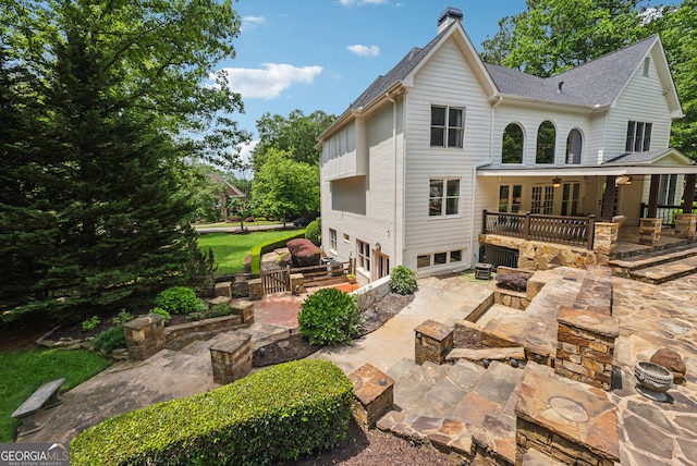 115 Hopewell Grove Dr, Milton, GA 30004 - rear view of property featuring a patio, an attached garage, a chimney, a shingled roof, and ceiling fan