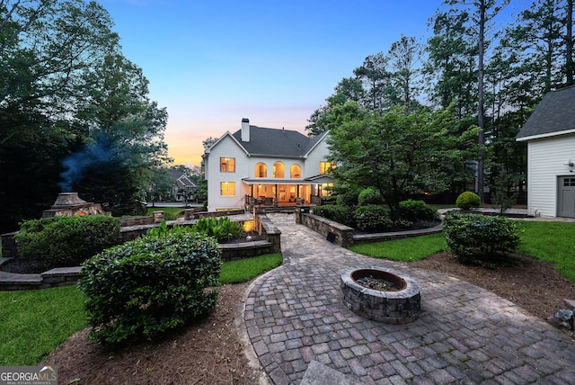 115 Hopewell Grove Dr, Milton, GA 30004 - back of property with a fire pit, a chimney, and a patio area