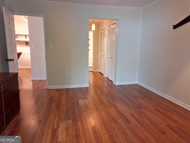 605 Candler St Unit A8, Gainesville, GA 30501 - empty room featuring dark wood-type flooring, baseboards, and crown molding