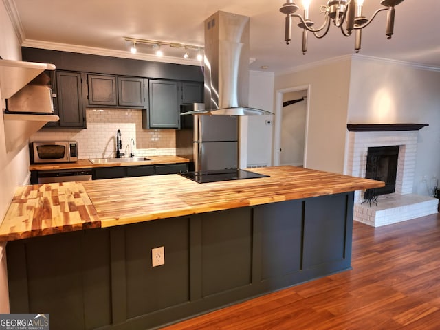 605 Candler St Unit A8, Gainesville, GA 30501 - kitchen featuring butcher block counters, a sink, stainless steel appliances, island range hood, and decorative backsplash