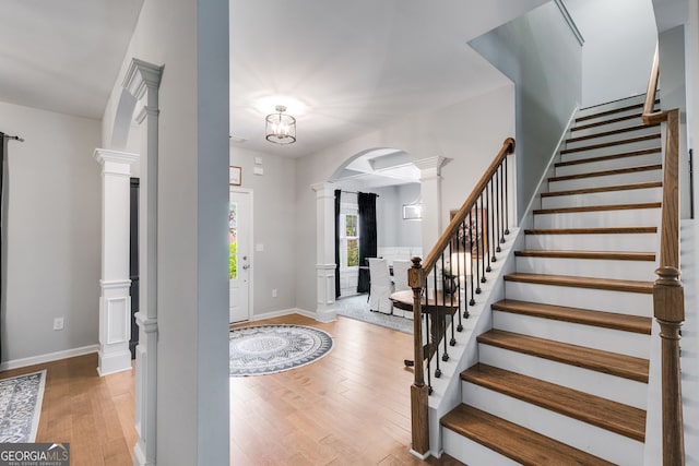 13 Westbrook Rd, Carrollton, GA 30116 - entrance foyer featuring decorative columns, arched walkways, wood finished floors, and stairway