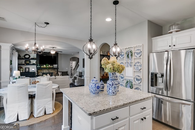 13 Westbrook Rd, Carrollton, GA 30116 - kitchen with stainless steel refrigerator with ice dispenser, arched walkways, ceiling fan, a center island, and wood finished floors