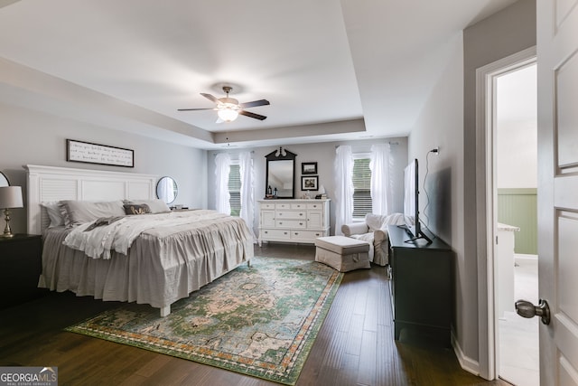 13 Westbrook Rd, Carrollton, GA 30116 - bedroom featuring multiple windows, dark wood-style flooring, a raised ceiling, a ceiling fan, and wainscoting