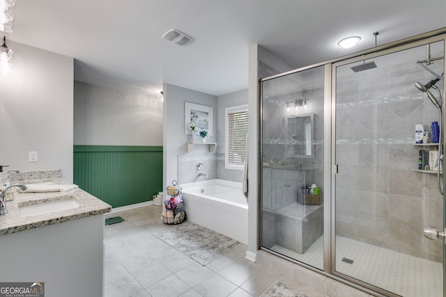 13 Westbrook Rd, Carrollton, GA 30116 - bathroom with a garden tub, a shower stall, tile patterned flooring, double vanity, and wainscoting