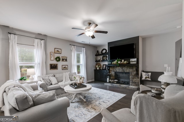 13 Westbrook Rd, Carrollton, GA 30116 - living room featuring ceiling fan, dark wood-type flooring, and a stone fireplace
