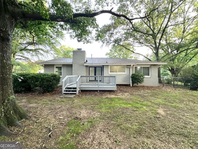 1918 Leigh Dr SW, Conyers, GA 30094 - rear view of house with brick siding, a chimney, and a deck