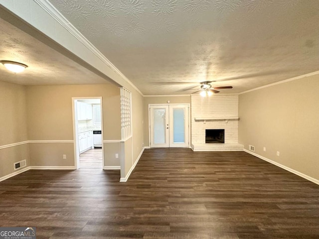 1918 Leigh Dr SW, Conyers, GA 30094 - unfurnished living room with a ceiling fan, dark wood-type flooring, baseboards, a brick fireplace, and a textured ceiling