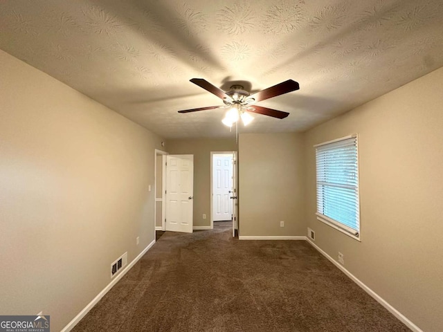 1918 Leigh Dr SW, Conyers, GA 30094 - empty room featuring a ceiling fan, baseboards, dark carpet, and a textured ceiling