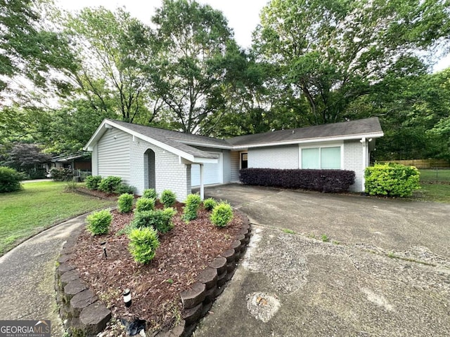 1918 Leigh Dr SW, Conyers, GA 30094 - ranch-style home with driveway, brick siding, a garage, and a front lawn