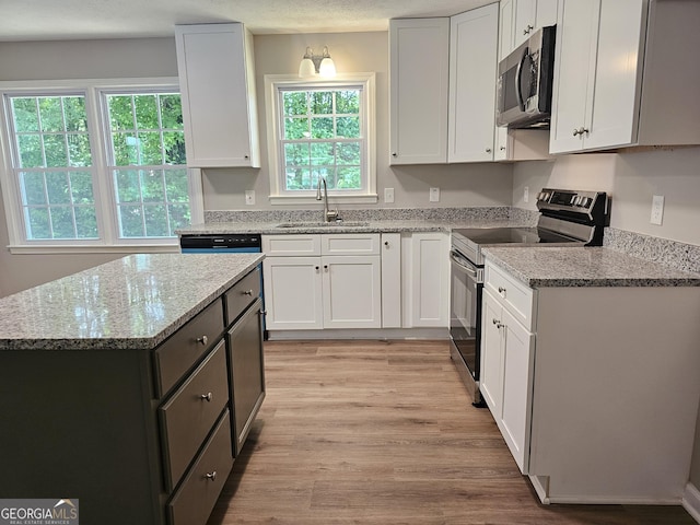 70 Shadow Ln, Carrollton, GA 30117 - kitchen featuring appliances with stainless steel finishes, a sink, and white cabinetry