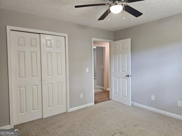 70 Shadow Ln, Carrollton, GA 30117 - unfurnished bedroom with carpet flooring, a closet, baseboards, a textured ceiling, and a ceiling fan