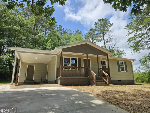 70 Shadow Ln, Carrollton, GA 30117 - view of front of house with crawl space, a carport, driveway, entry steps, and covered porch