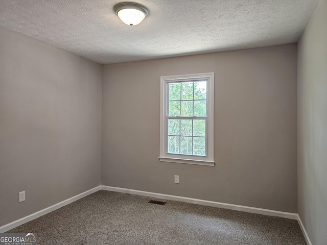 70 Shadow Ln, Carrollton, GA 30117 - empty room featuring a textured ceiling, carpet flooring, and baseboards