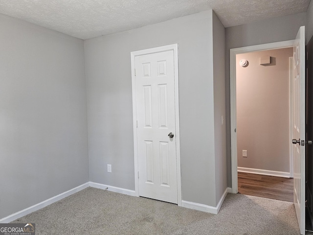 70 Shadow Ln, Carrollton, GA 30117 - unfurnished bedroom featuring carpet flooring, baseboards, and a textured ceiling