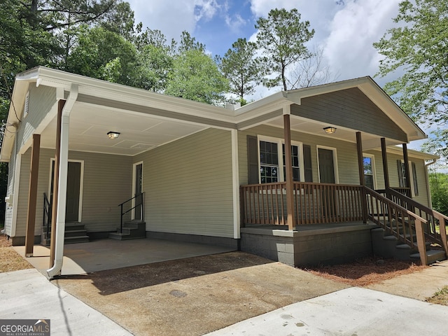 70 Shadow Ln, Carrollton, GA 30117 - view of front of home featuring entry steps, driveway, a carport, and covered porch