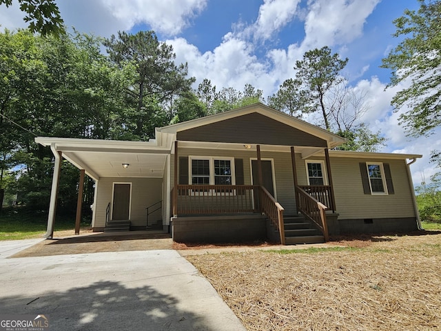 70 Shadow Ln, Carrollton, GA 30117 - view of front of house with crawl space, driveway, an attached carport, covered porch, and entry steps
