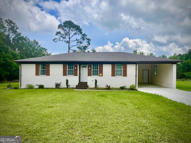1962 Anderson Rd, Rentz, GA 31075 - ranch-style home with concrete driveway, brick siding, a carport, and a front yard
