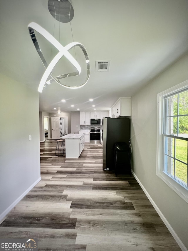 1962 Anderson Rd, Rentz, GA 31075 - unfurnished living room with baseboards, recessed lighting, and wood finished floors