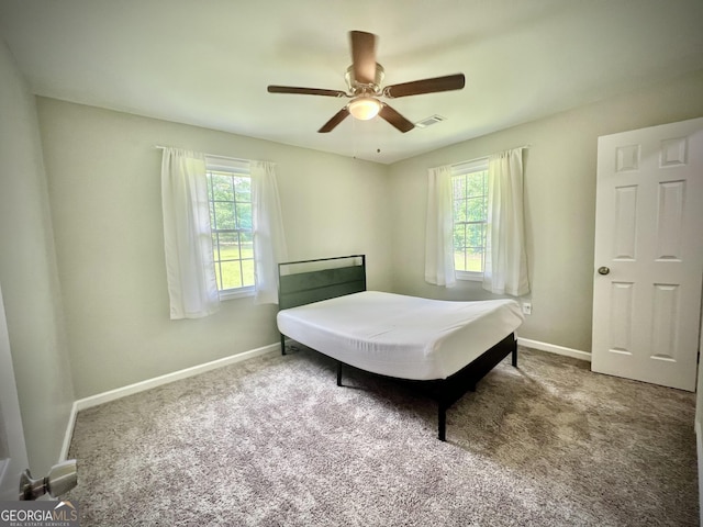 1962 Anderson Rd, Rentz, GA 31075 - bedroom with multiple windows, baseboards, carpet floors, and a ceiling fan